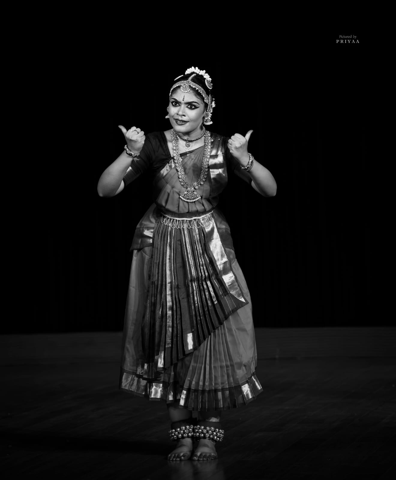 Bharatanatyam dancer in traditional costume, black and white, full-length pose