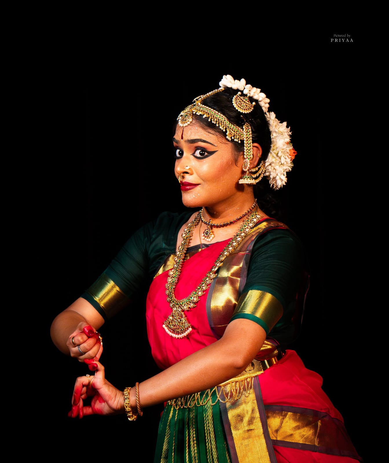 Bharatanatyam dancer mid-expression with an intricate gesture
