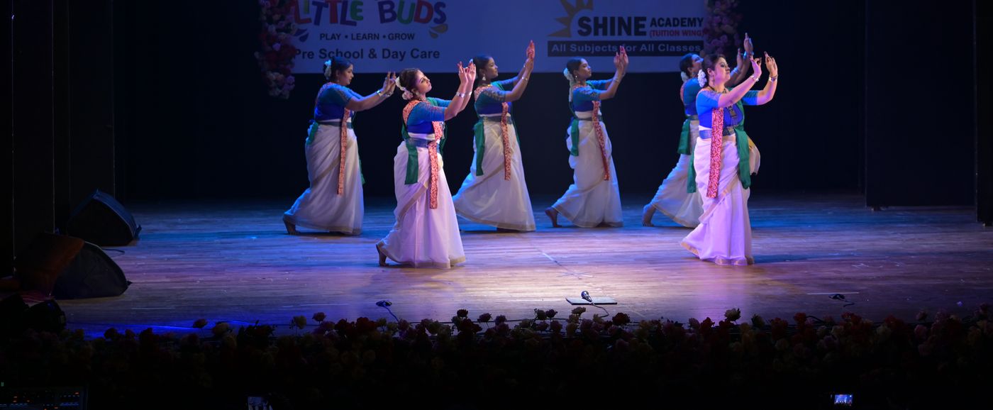 A group of Rabindranritya dancers performing together on stage